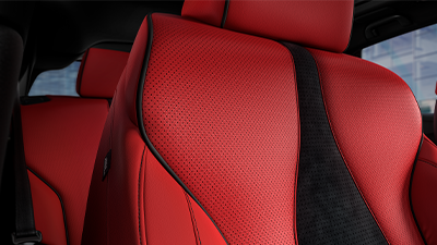 Close-up interior shot of an Acura driver's seat, with bright red upholstery and black design accents.